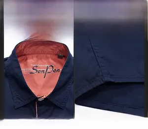 Detailed view of navy blue cotton shirt collar with button-down design and contrast lining