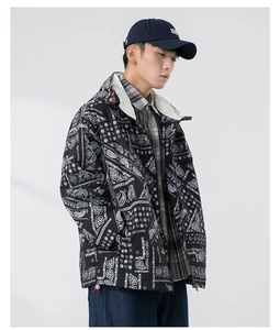 Detail of men's black jacket featuring white paisley print with zipper and hood