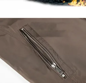 Close-up detail of casual brown jacket featuring a metallic zipper and side slant pocket