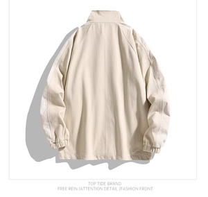 Detail view of beige jacket back featuring paisley patterned side tape on sleeves