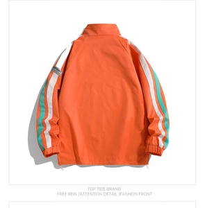 Detail of orange casual jacket featuring striped sleeves and adjustable drawstring hem