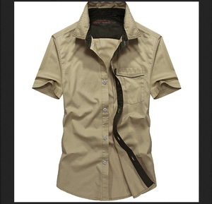 Detail of khaki men's short sleeve shirt showing contrast piping and metal button accents