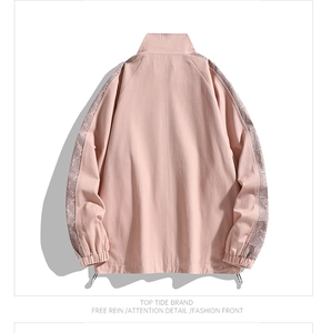 Detail view of pink jacket back featuring paisley side tape and adjustable black drawstrings