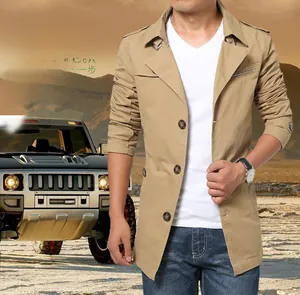 Close-up of khaki cotton trench coat with shoulder epaulets and decorative chest zipper