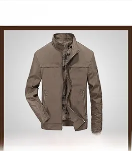 Detail of khaki military style jacket showing stand collar, zipper pockets and vintage lining
