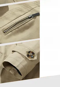 Detail of khaki cotton jacket showing decorative zip pocket and buttoned sleeve cuffs