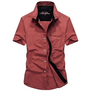 Men's brick red short sleeve cotton shirt with black trim collar and chest pocket
