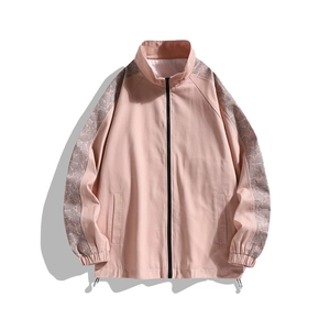 Pink stand collar work jacket with gray paisley print sleeves and front zip closure