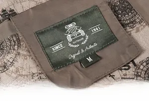 Detail of outdoor jacket collar label with vintage map lining and size M embroidery