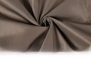 Detailed close-up of dark brown water-resistant jacket fabric with premium double-stitch seam