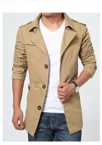 Detail of khaki men's trench coat featuring wide lapels and amber-patterned buttons