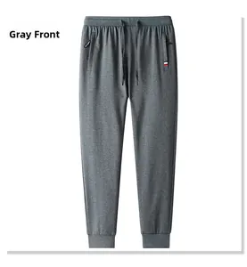 Detail view of dark grey sports joggers with drawstring waist and zipper pockets