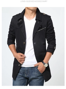 Detail of men's black trench coat with shoulder epaulets and chest zipper accents
