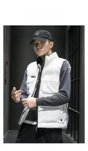 Detailed view of white padded vest featuring utility flap pockets and a tall stand collar
