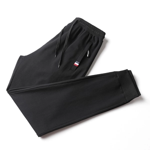 Men's slim fit black joggers with drawstring waist and tricolor tape detail on pocket