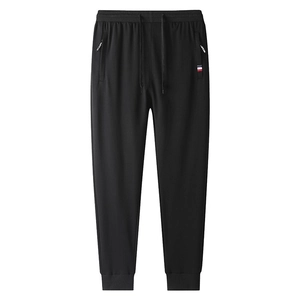 Men's black slim fit joggers with drawstring waist and zippered pockets on white background