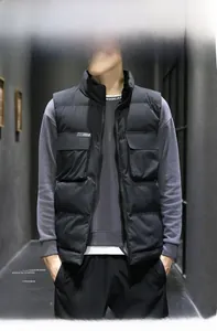 Detail view of men's black padded gilet with stand collar and functional large pockets