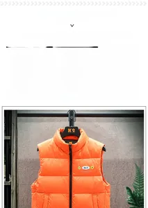 Detail of bright orange puffer vest with stand-up collar, quilting and ELT chest badge