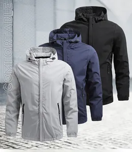 Detail of hooded windbreaker jackets in light grey, navy, and black with zippered pockets