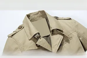 Detail of khaki cotton jacket showing lapel collar, epaulettes, and plaid lining