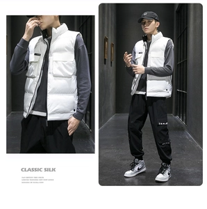 Detail of white padded vest with stand collar and large cargo pockets for winter
