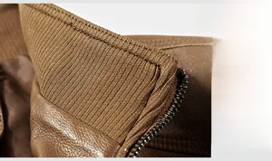 Detail of brown leather jacket neckline with knitted rib inner collar and metal zipper