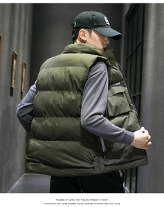Detail of army green puffer vest showing tactical side pocket and utility stitching