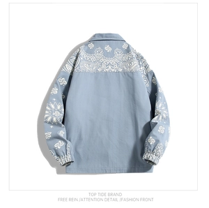 Detail view of light blue jacket back with white paisley and sunflower patterns