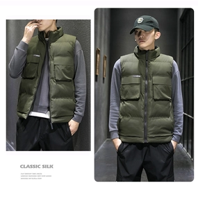 Detail view of olive green puffer vest with large pockets and high neck stand collar