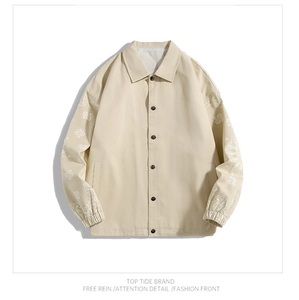 Detail of light beige work jacket featuring paisley print on sleeves and button-up front