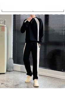 Close-up of black and white paneling on long sleeve sweatshirt and matching sweatpants