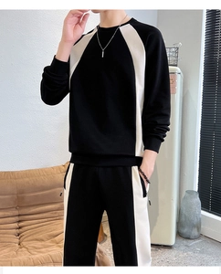 Detail of men's crewneck tracksuit featuring high-contrast black and white paneling design