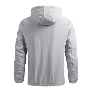 Back view of a lightweight light gray hooded windbreaker jacket with elastic cuffs