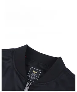 Detail shot of black MA-1 flight jacket showing knit baseball collar and military inner tag
