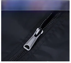 Close-up of a durable black metal zipper on a men's flight bomber jacket sleeve