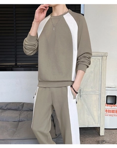 Detailed close-up of khaki cotton blend sweatshirt and pants set with white contrast panels