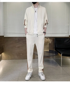 Detail of men's cream tracksuit with brown side stripes and ribbed zip-up stand collar