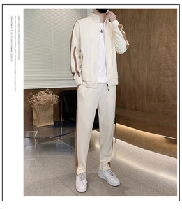 Detail view of cream casual tracksuit with brown side stripes on jacket and pants