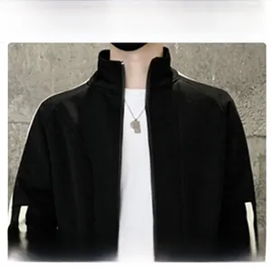 Detailed view of the black sports jacket collar with white contrast stripes and zipper