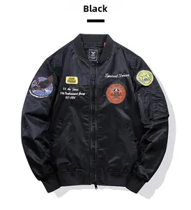 Close-up of black MA-1 flight jacket featuring military patches and sleeve utility pocket