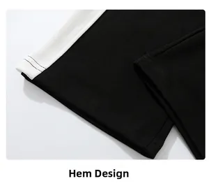 Detail of black sweatpants leg opening with white side stripes and reinforced stitching