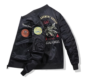 Detail of black military pilot jacket featuring U.S.A.F embroidery and aircraft graphics
