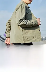 Detail of khaki cargo shirt with buttoned pockets and durable cotton twill fabric