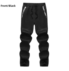 Détail du pantalon de sport noir avec taille élastique, cordon et finitions en maille argent