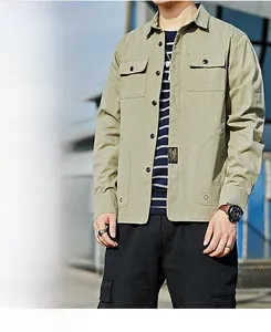 Detail of khaki cargo jacket featuring chest flap pockets and lettered woven patch label