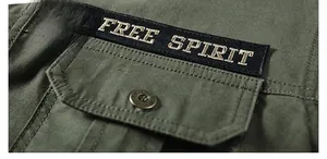 Close-up of military green twill cotton shirt featuring FREE SPIRIT embroidered patch