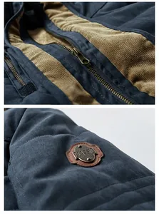 Close-up of classic metallic zipper and vintage embroidered patch on blue cotton jacket