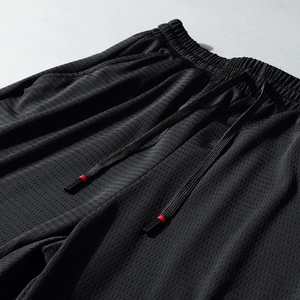 Black summer athletic pants with breathable mesh fabric and elastic drawstring waistband