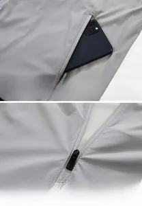 Détail de la poche latérale invisible et du zip métallique premium sur la veste grise