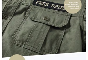 Detail of army green shirt featuring a flap pocket with Free Spirit embroidery and metal buttons